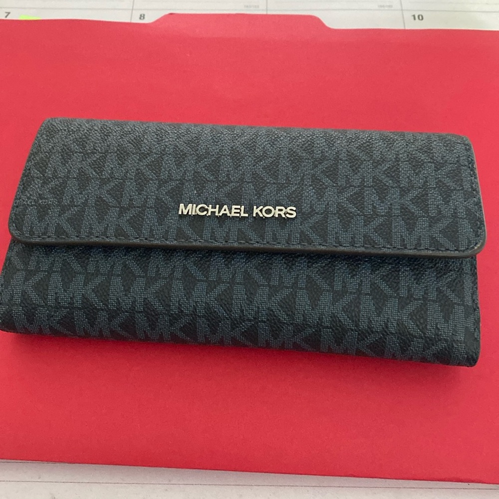 Michae Kors Wallet- This wallet is brand new.  Never carried.  Tri-fold clutch